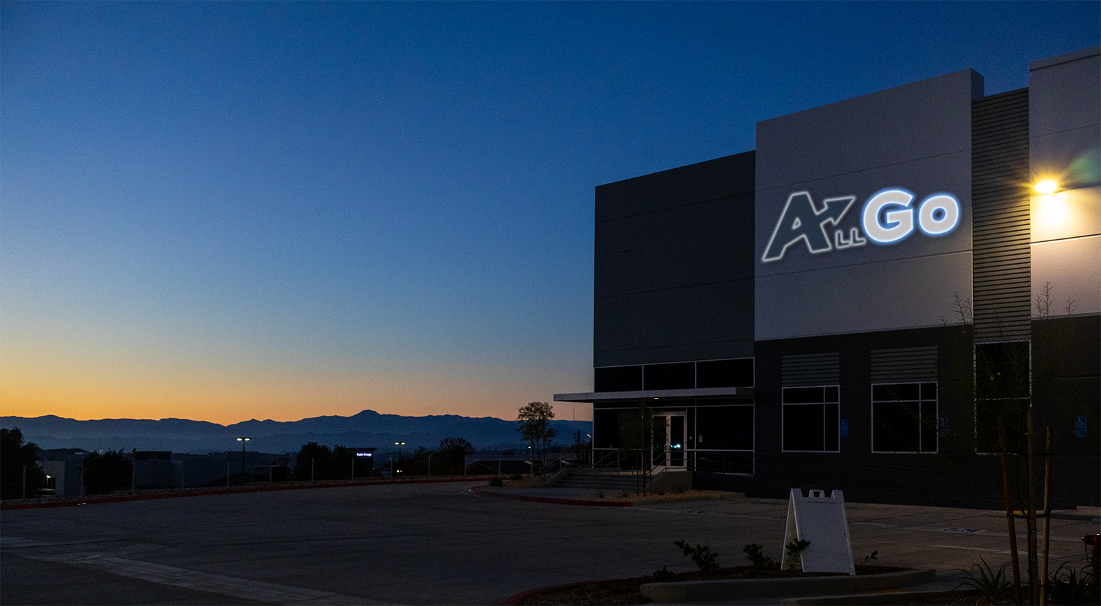 The AllGo warehouse main entrance, with the sun just having dipped below the horizon