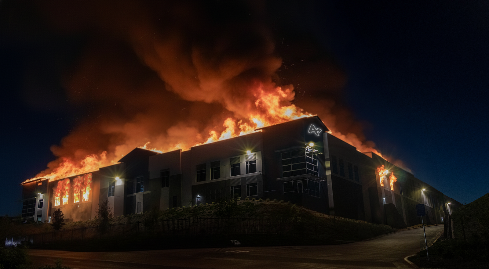 AllGo warehouse engulfed in flame, just before daybreak