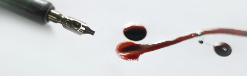 An abandoned fountain pen lays on a blood stained piece of paper.